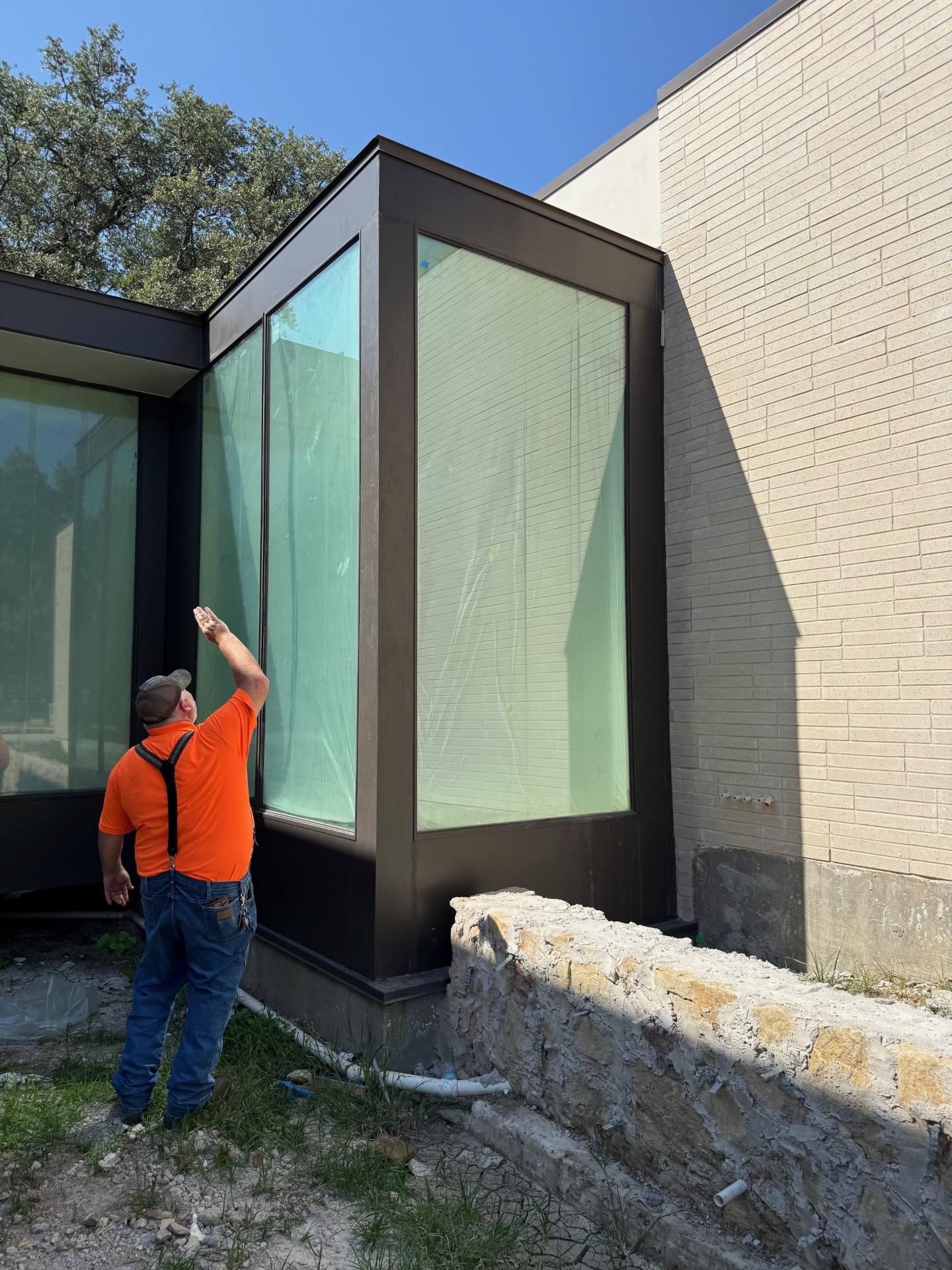 Blade Glazing technician installing structural glass on site