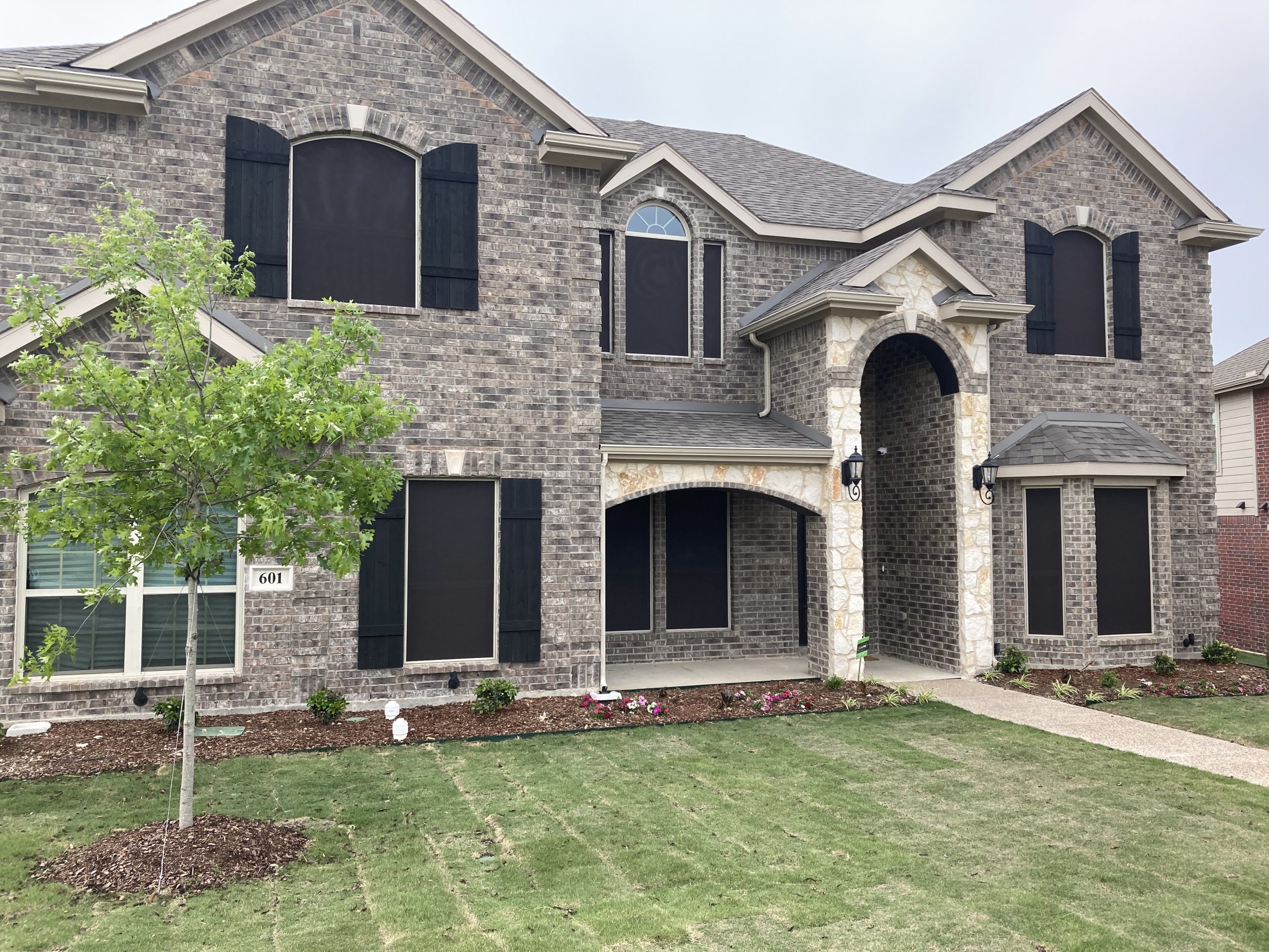 Solar screens on a two story brick home