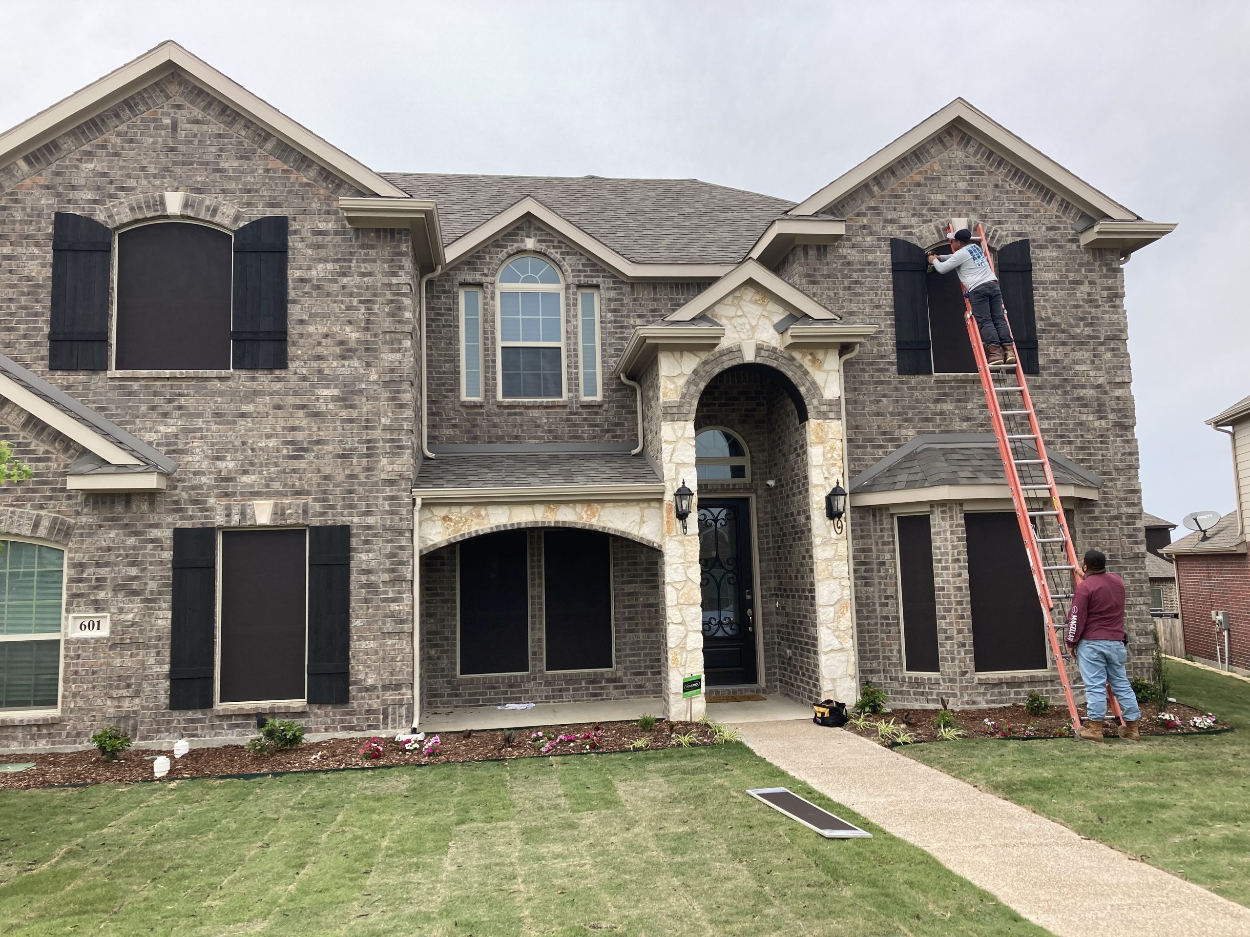 Solar screen installation on a brick home